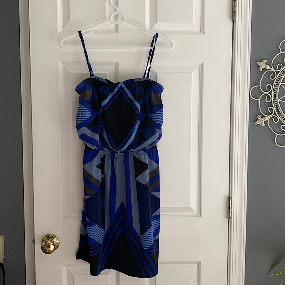 Dress can be worn with or without straps. Above the knee. Little stretch.